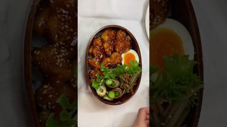 3月16日(木)の旦那弁当/＊ヤンニョムチキン＊ゆで卵＊わかめと竹輪の生姜お浸し＊アスパラのベーコン巻き＊きんぴらごぼう＊サラダ＊伊予柑